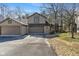 Inviting home exterior showcasing a two-car garage and well-maintained landscaping at 2215 Van Ness Pl, Indianapolis, IN 46240