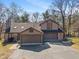 Inviting home with a two-car garage, stone accents, gabled roof, and well-maintained landscaping for curb appeal at 2215 Van Ness Pl, Indianapolis, IN 46240