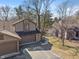 Beautiful home with a two-car garage, stone details, manicured lawn, and mature trees in a desirable neighborhood at 2215 Van Ness Pl, Indianapolis, IN 46240