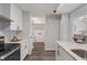 Spacious kitchen with white cabinets, stainless appliances, subway tile, and walk-in pantry/laundry area at 2215 Van Ness Pl, Indianapolis, IN 46240