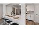 Bright kitchen features white cabinets, stainless steel appliances, and a breakfast bar with seating at 2215 Van Ness Pl, Indianapolis, IN 46240