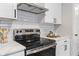 Close up of a kitchen featuring stainless steel appliances, subway tile backsplash, and quartz countertops at 2215 Van Ness Pl, Indianapolis, IN 46240