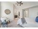 Bright main bedroom featuring a ceiling fan, neutral walls, and ensuite bathroom access at 2215 Van Ness Pl, Indianapolis, IN 46240