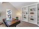 Well-lit office area featuring custom shelving, a built-in bookcase and ample natural light at 2215 Van Ness Pl, Indianapolis, IN 46240