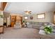 Cozy basement featuring a large sectional sofa, built-in shelving, a ceiling fan, and comfortable seating at 229 W Taylor St, Pendleton, IN 46064