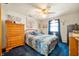 Stylish bedroom with a ceiling fan, dresser, and large windows, offering comfort and elegance at 229 W Taylor St, Pendleton, IN 46064