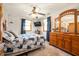 Bedroom features a ceiling fan, dresser, and windows, creating a serene space at 229 W Taylor St, Pendleton, IN 46064