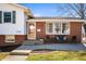 Inviting front porch with comfortable seating, charming brick details, and a well-maintained lawn at 229 W Taylor St, Pendleton, IN 46064