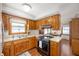 Functional kitchen with wood cabinets, modern appliances, and ample counter space, flowing into the dining area at 229 W Taylor St, Pendleton, IN 46064