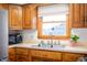 Bright kitchen featuring wood cabinets, stainless steel appliances, and a stainless steel sink at 229 W Taylor St, Pendleton, IN 46064