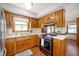 Traditional eat-in kitchen with oak cabinets, stainless appliances, and neutral countertops for a warm, inviting feel at 229 W Taylor St, Pendleton, IN 46064