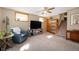 Comfortable carpeted living room with a ceiling fan, large TV, and cozy chair, perfect for relaxation at 229 W Taylor St, Pendleton, IN 46064