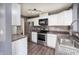 Well-equipped kitchen with stainless steel appliances, stylish backsplash, and ample cabinet space for storage at 240 Legends Creek # 206, Indianapolis, IN 46229