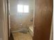 Bathroom featuring a bathtub, a window letting in natural light, and wood flooring at 260 W 33Rd St, Indianapolis, IN 46208