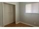 Bedroom with hardwood floors, a window with blinds, and a spacious closet at 260 W 33Rd St, Indianapolis, IN 46208