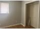 Bedroom with a window letting in natural light and a closet with shelving at 260 W 33Rd St, Indianapolis, IN 46208