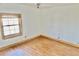 Bedroom featuring wood floors and a window with wood trim and blinds at 2839 E 19Th St, Indianapolis, IN 46218