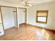 Bedroom featuring wood-look flooring, a ceiling fan and two closets at 2839 E 19Th St, Indianapolis, IN 46218