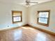 Bedroom featuring wood-look flooring, a ceiling fan and two windows at 2839 E 19Th St, Indianapolis, IN 46218