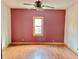 Bedroom with a window, ceiling fan, and hardwood floors at 2839 E 19Th St, Indianapolis, IN 46218