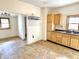 Kitchen with wooden cabinets, window, vinyl floors and appliances at 2839 E 19Th St, Indianapolis, IN 46218