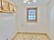 Bright kitchen featuring upper wood cabinets and a window with wood trim at 2839 E 19Th St, Indianapolis, IN 46218