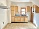 Kitchen featuring wooden cabinets, window, and vinyl floors at 2839 E 19Th St, Indianapolis, IN 46218