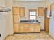 Kitchen with wood cabinets, stainless steel sink, and window above the sink at 2839 E 19Th St, Indianapolis, IN 46218