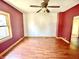 Bright living room featuring a ceiling fan, wood floors, and large window at 2839 E 19Th St, Indianapolis, IN 46218