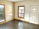 Bright living room with hardwood floors, featuring natural light from large windows and a white door at 2839 E 19Th St, Indianapolis, IN 46218