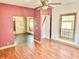 Living room with wood-look flooring, natural wood trim and view into other rooms at 2839 E 19Th St, Indianapolis, IN 46218
