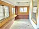 Bright sunroom featuring brick accents, wood framed windows, and an abundance of natural light at 2839 E 19Th St, Indianapolis, IN 46218