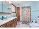 Well-lit bathroom featuring a single sink vanity, toilet, and tiled floors at 300 S Market St, Thorntown, IN 46071