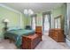 Cozy bedroom with vintage decor, wooden furniture, and a bright chandelier at 300 S Market St, Thorntown, IN 46071