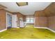 Upper level bedroom with wooden walls features a small kitchen area, window, and carpeted floor at 300 S Market St, Thorntown, IN 46071