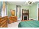 Bright bedroom featuring a decorative fireplace, wooden dresser, and natural light at 300 S Market St, Thorntown, IN 46071