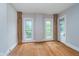 Bright bedroom with hardwood floors, two windows, and fresh, neutral walls at 300 S Market St, Thorntown, IN 46071