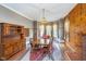 Charming dining area featuring a vintage hutch, bay windows, and hardwood floors at 300 S Market St, Thorntown, IN 46071