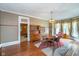Traditional dining room with a wooden table, vintage hutch, and bay window at 300 S Market St, Thorntown, IN 46071