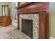 Antique fireplace with decorative tiles and wooden mantel adding timeless charm and warmth to the room at 300 S Market St, Thorntown, IN 46071