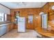 Functional kitchen with wood paneling and vintage appliances at 300 S Market St, Thorntown, IN 46071