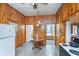 Simple kitchen with wood paneling, practical appliances, and casual dining area at 300 S Market St, Thorntown, IN 46071