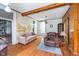Cozy living room features hardwood floors, wood beams, and a unique wall mural at 300 S Market St, Thorntown, IN 46071