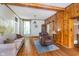 Bright living room boasts hardwood floors, natural light, and rustic wood paneling at 300 S Market St, Thorntown, IN 46071