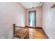 Upper staircase landing with patterned wallpaper, and natural light from a window at 300 S Market St, Thorntown, IN 46071