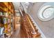Staircase with wood detailing, bookshelves, and unique decorative round window at 300 S Market St, Thorntown, IN 46071