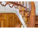 Classic wooden staircase with decorative trim and paneling adds charm to the home at 300 S Market St, Thorntown, IN 46071