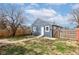A backyard view featuring the house's back, a quaint yard, and a concrete pathway at 301 Villa Ave, Indianapolis, IN 46201