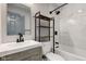 Stylish bathroom featuring a tiled shower, gray vanity, black fixtures, and storage shelves at 301 Villa Ave, Indianapolis, IN 46201