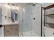 Modern bathroom with a glass shower, wood vanity, black faucet and fixtures, and a tiled wall at 301 Villa Ave, Indianapolis, IN 46201